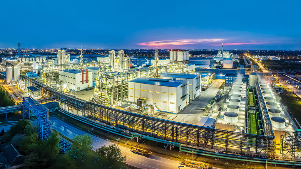 Industrieanlage bei Dämmerung unter blauem Himmel, die eine ruhige und produktive Atmosphäre ausstrahlt